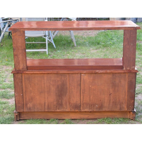 3588 - A Victorian mahogany buffet, the lower section enclosed by three panelled doors with open centre, th... 