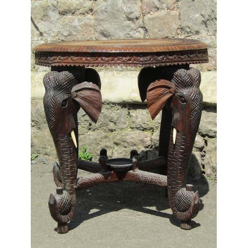 3597 - An Indian hardwood occasional table of circular form with repeating geometric detail raised on four ... 