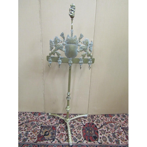 3621 - A cast brass hearth side companion stand on rope twist borders, the armorial panel flanked by two li... 