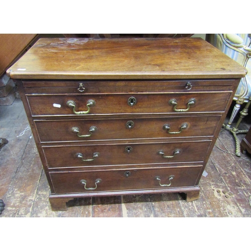 3623 - A small Georgian mahogany chest of four long graduated drawers with brush slide on bracket supports,... 