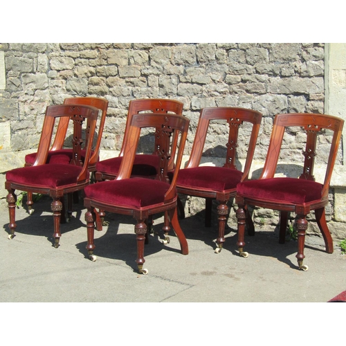 3634 - A set of six Victorian mahogany dining chairs with carved and pierced splats, upholstered seats, flu... 