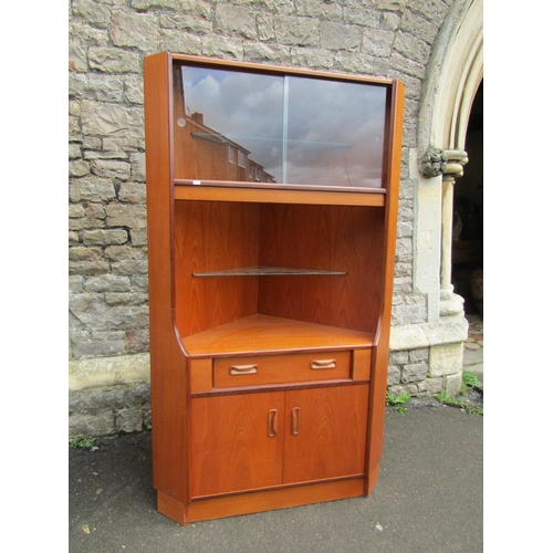 3042 - G Plan teak open corner cupboard, partially enclosed by a pair of panelled doors and a frieze drawer... 