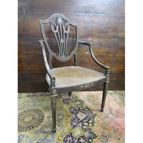 3516 - A regency shield back elbow chair, with cane panelled seat, raised on square tapered legs, with over... 