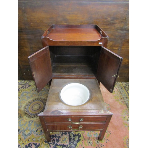 3546 - A Georgian mahogany tray top commode, the front elevation enclosed by a pair of panelled doors over ... 