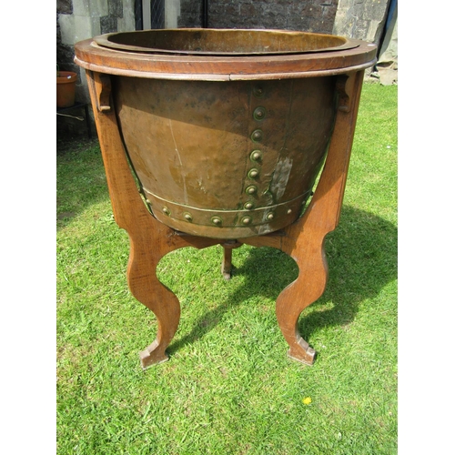 3626 - A 19th century rivetted copper cauldron set within a bespoke oak framework presented as a jardiniere... 