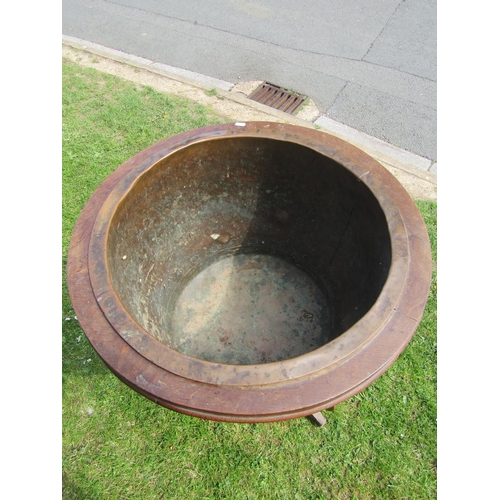 3626 - A 19th century rivetted copper cauldron set within a bespoke oak framework presented as a jardiniere... 