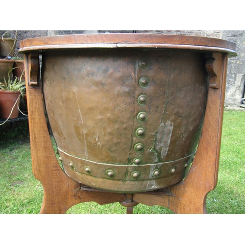 3626 - A 19th century rivetted copper cauldron set within a bespoke oak framework presented as a jardiniere... 