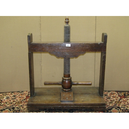 3531 - A Georgian oak linen/clothes press, the central screw thread surmounted by an acorn, set on a platfo... 