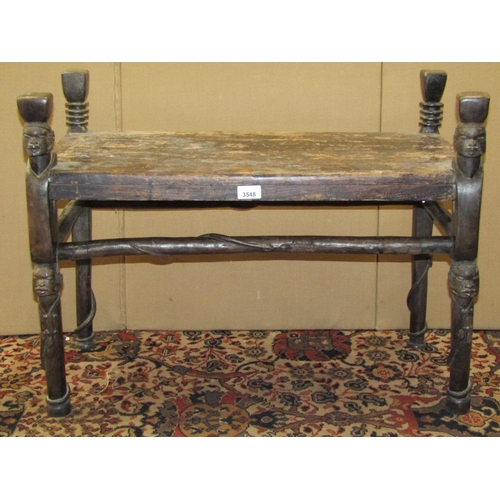 3548 - An unusual rectangular African hardwood side table, with carved mask detail, the rails with serpent ... 