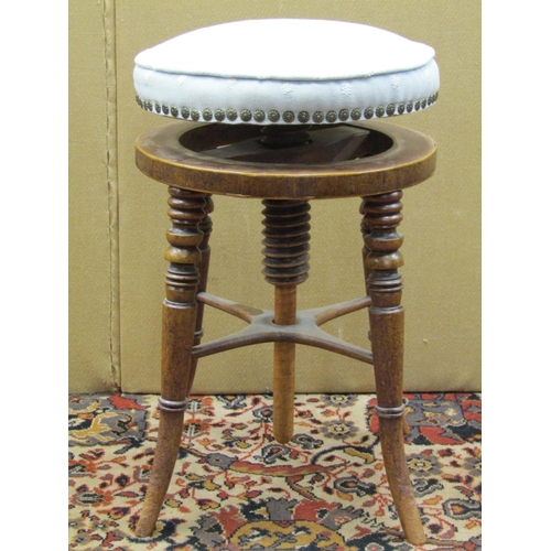 3578 - A Regency mahogany piano stool the circular upholstered top raised on four swept supports, together ... 