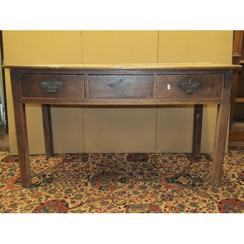 3579 - An 18th century country made oak side table fitted with three frieze drawers on square cut supports,... 