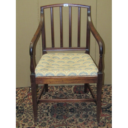 3607 - A Georgian mahogany stick back elbow chair with upholstered seat on square taper legs