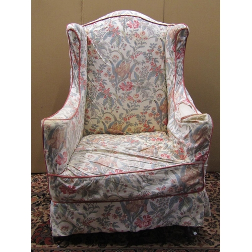 3612 - A 19th century wing chair with shaped arms and cabriole forelegs