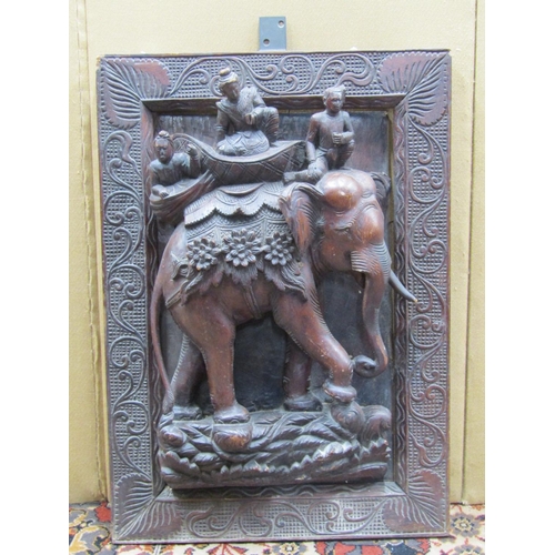 3627 - A carved Eastern hardwood panel the deep relief showing an elephant and riders in a carved framework... 