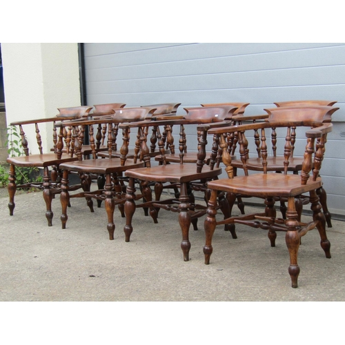 3637 - A perfectly matched set of eight 19th century Windsor smokers bow elbow chairs, in elm and beech, wi... 