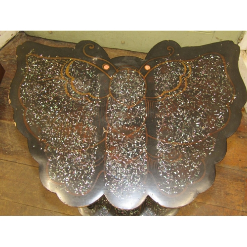 3042A - A lacquered and mother of pearl inlaid occasional table with two butterfly shaped tiers