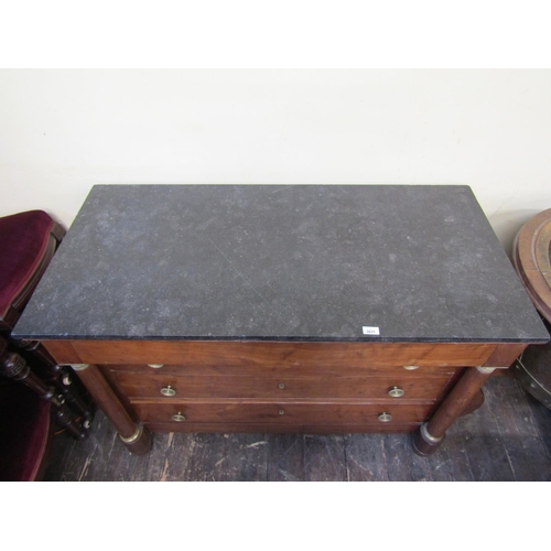 3631 - Early 19th century French Empire period walnut commode of four drawers with turned column supports, ... 