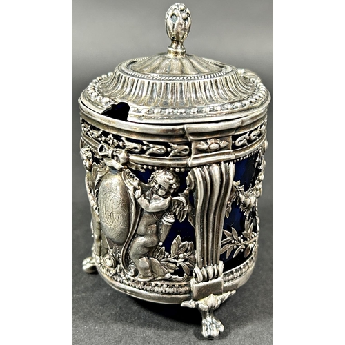 1193 - A Dutch mid 19th century silver mustard pot with blue glass liner, decorated with cherubs and fruit ... 