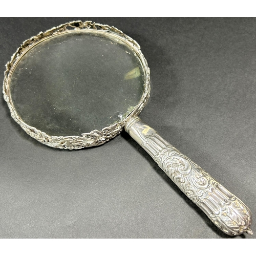 1200 - A silver mounted magnifying glass, London 1891, maker William Comyns & Sons, an oval silver photo fr... 