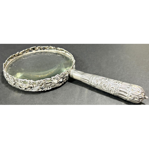 1200 - A silver mounted magnifying glass, London 1891, maker William Comyns & Sons, an oval silver photo fr... 