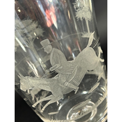 1125 - A large glass or vase with an engraved huntsman on horseback with fox hounds, on a rounded foot, 24.... 