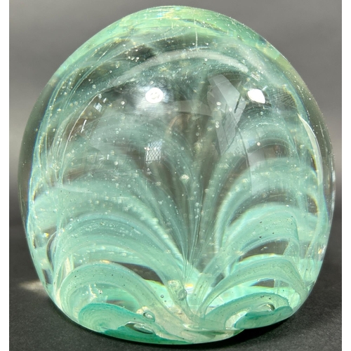 1148 - A Victorian pale green glass dump with grass like silvery internal decoration, 9cm high.