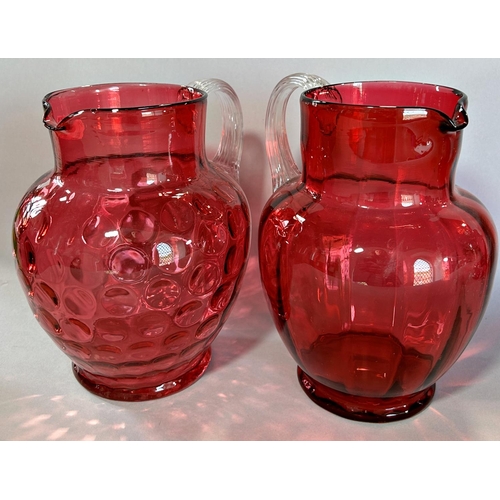 1142 - Two cranberry coloured ewers with celery handles, Mary Gregory jar and cover and two trumpet shaped ... 