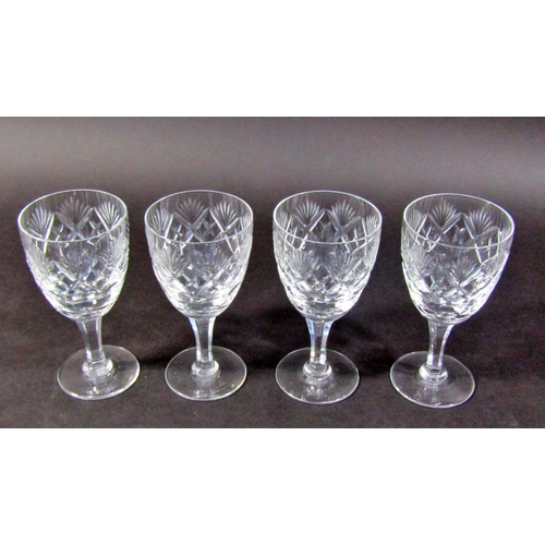 1135 - Four Victorian style thistle cut glass wine glasses on faceted stems.