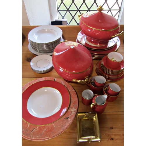 1005 - A collection of gilt edged and terracotta coloured Legle Limoges porcelain dinner wares to include t... 