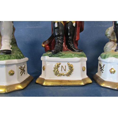 1011 - A collection of fourteen Napoleonic figures in military costume, 30cm tall approx