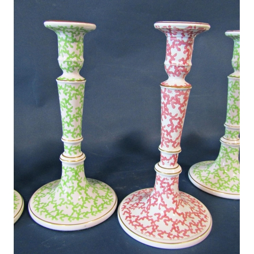 1013 - Five ceramic candlesticks with scrolling printed decoration, four in green, one in red, 28cm tall ap... 