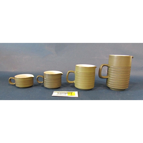 1014 - A collection of Denby table wares with olive green glaze and impressed chevron decoration to include... 