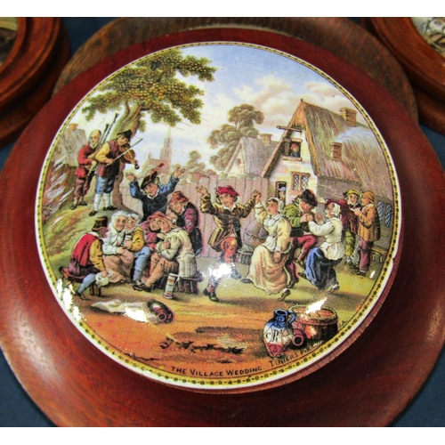 1035 - A collection of Pratt ware ceramic pot lids, each depicting a different scene, some with wooden moun... 