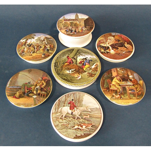 1035 - A collection of Pratt ware ceramic pot lids, each depicting a different scene, some with wooden moun... 