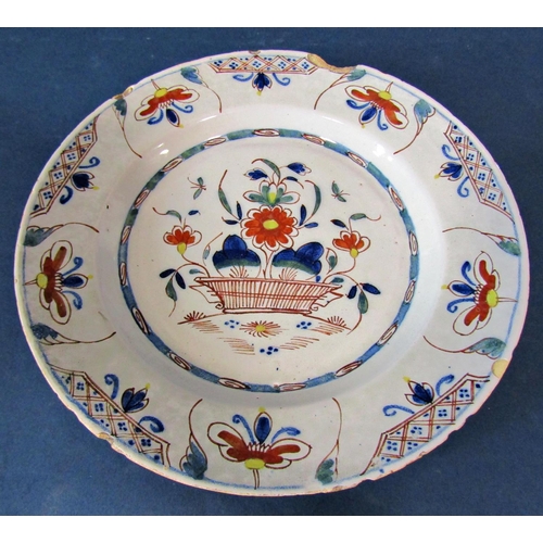 1037 - An 18th century English Delft tin glazed earthenware plate centrally decorated with a basket of flow... 