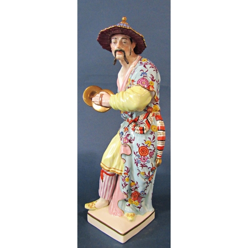 1040 - Two hand-painted porcelain Chinoiserie figures of men in traditional dress, one holding cymbals, tal... 