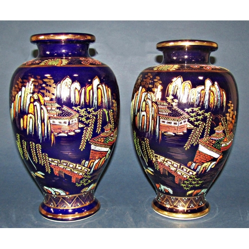 1043 - Pair of blue ground vases with oriental scene decoration, together with a further vase with cream gr... 