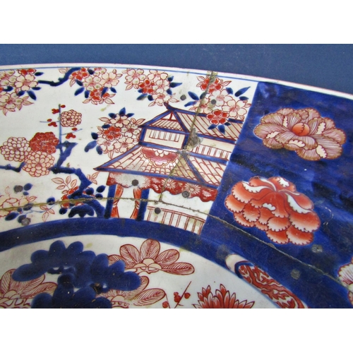 1054 - Large 19th Century Oriental Imari Charger, on a stand with turned cross-stretcher base, dish 60 diam... 