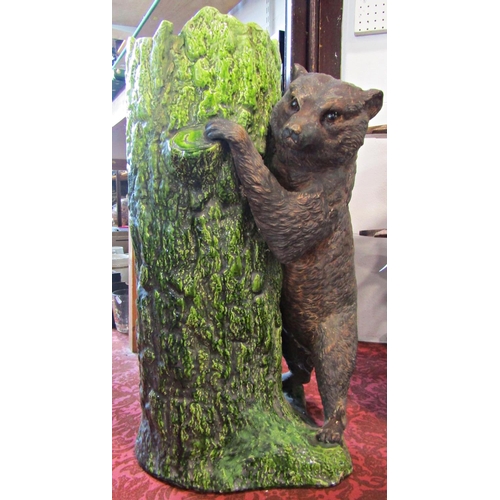 1089 - A Bretbyware stick stand modelled as a tree trunk bear cub, naturalistic painted finish