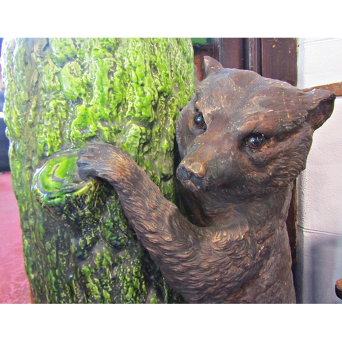 1089 - A Bretbyware stick stand modelled as a tree trunk bear cub, naturalistic painted finish