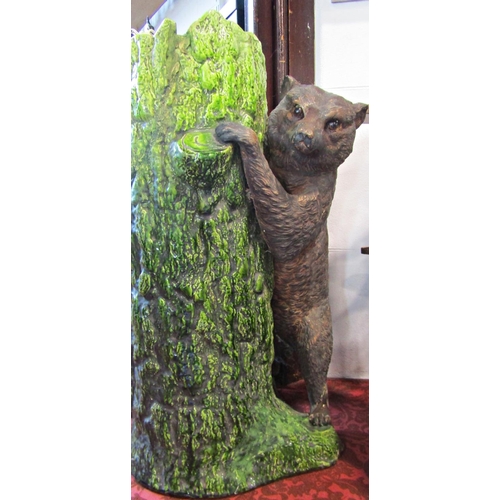 1089 - A Bretbyware stick stand modelled as a tree trunk bear cub, naturalistic painted finish