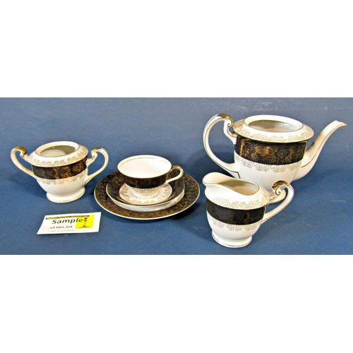 1114 - A George Jones collection of teawares (manufactured for Harrods) with shaped outline and blue and gi... 