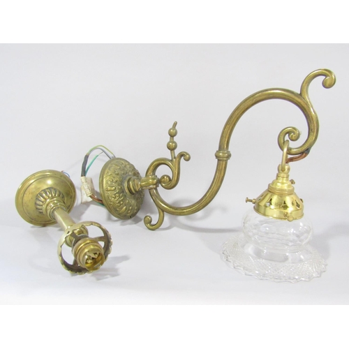 1471 - A brass scrolled wall light with a dangling glass shade, and a section of another brass light fittin... 