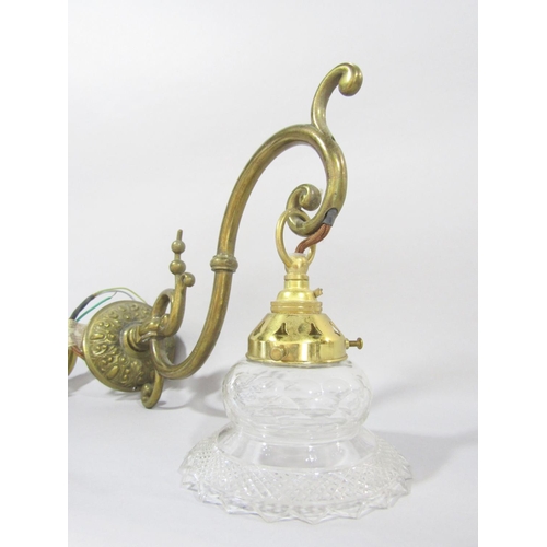 1471 - A brass scrolled wall light with a dangling glass shade, and a section of another brass light fittin... 