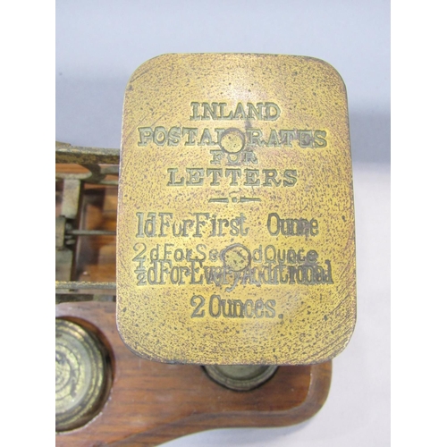 1477 - A set of 19th century brass postal scale on an oak stand, with some odd weights, together with a    ... 