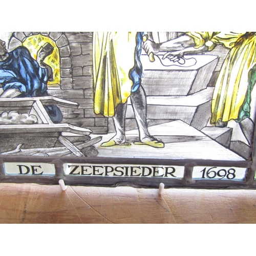 1486 - A leaded stained glass panel “De Zeepsieder 1698” (The Soap Maker) 28cm x 24cm.