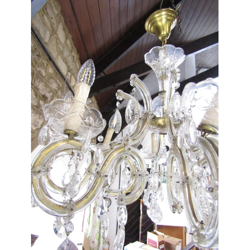 1490 - A Regency style eight branch brass and glass chandelier festooned with facetted droplets. Approximat... 