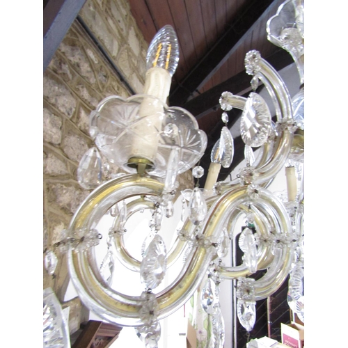 1490 - A Regency style eight branch brass and glass chandelier festooned with facetted droplets. Approximat... 