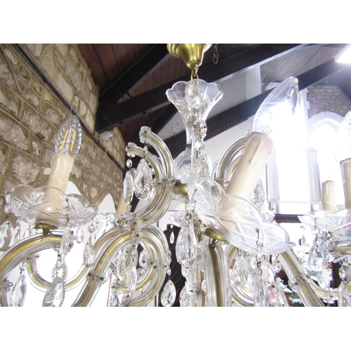 1490 - A Regency style eight branch brass and glass chandelier festooned with facetted droplets. Approximat... 