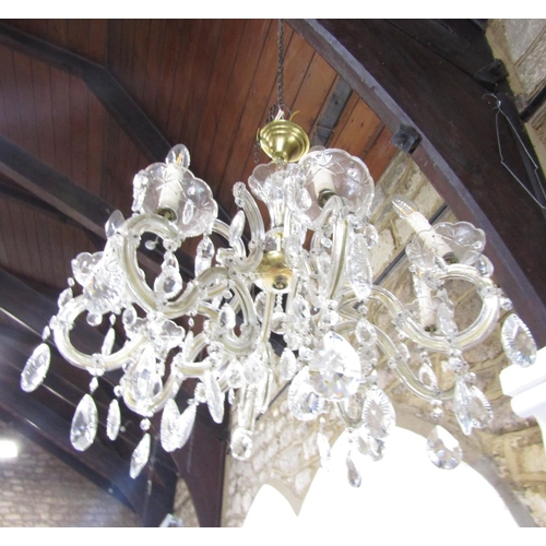 1490 - A Regency style eight branch brass and glass chandelier festooned with facetted droplets. Approximat... 